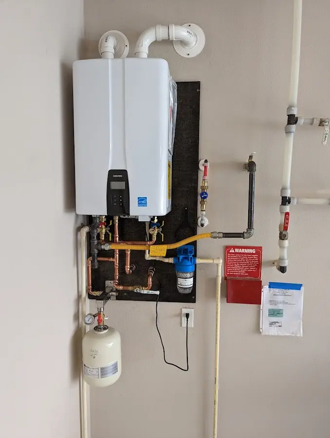 Professional plumber installing copper piping in a Sunset home
